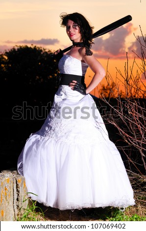 young woman in wedding dress at sunset