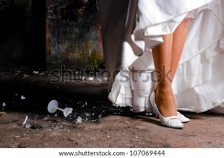 young woman in wedding dress at abandoned place