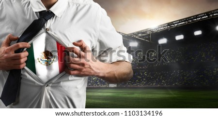 Mexico soccer or football supporter showing flag under his business shirt on stadium.
