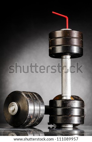 sport nutrition. metal barbells with red straw