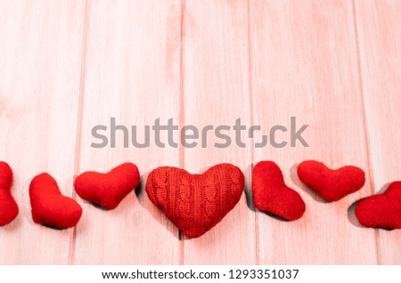 Set of glossy and craft red hearts for Valentine\'s day on living coral colored wooden table