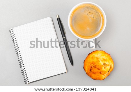 creative process. blank notebook and cup on gray