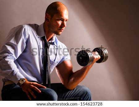 strong business man is raising a dumbbell