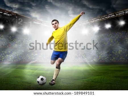 soccer or football player is kicking ball on stadium soccer or football player is kicking ball on stadium