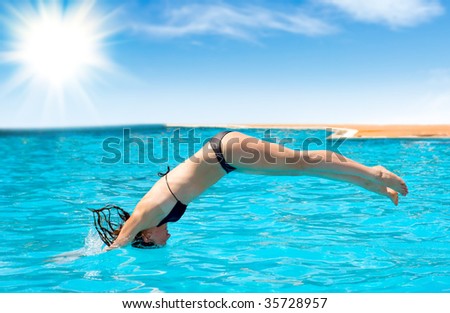 woman jumping into the pool