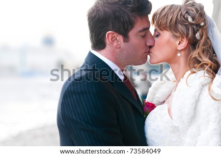 just married couple is kissing at street