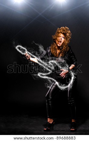 woman is playing rock music on fiery guitar