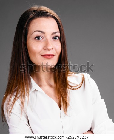 Portrait of happy smiling business woman on gray background