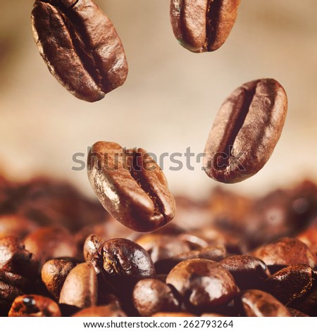 roasted coffee beans is falling down, warm colors toned
