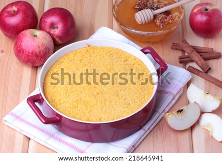 couscous casserole kodafa with apples, honey and cinnamon on wooden background