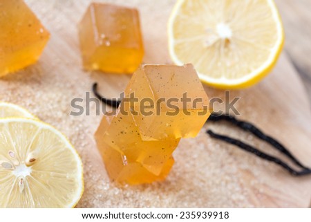 Lemon jujube, marmalade, candied fruit jelly with cinnamon, slices and half of lemon on a wooden table