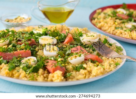 Tasty breakfast dish kedgeree, made with hot smoked salmon, egg, rice, curry powder and parsley. Traditional british dish.