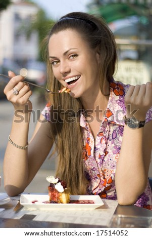 beautiful woman eating pie in cafe