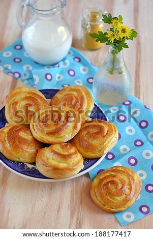 Custard rolls pastry with milk on wooden background