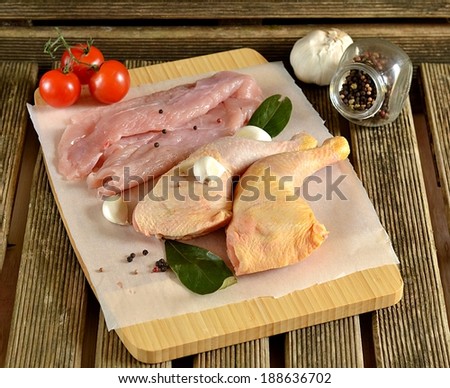 Fresh chicken meat on a cutting board. Selective focus. Rustic style