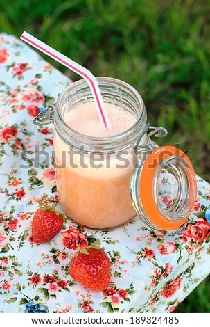 Milk shake with strawberries in summer day. Selective focus