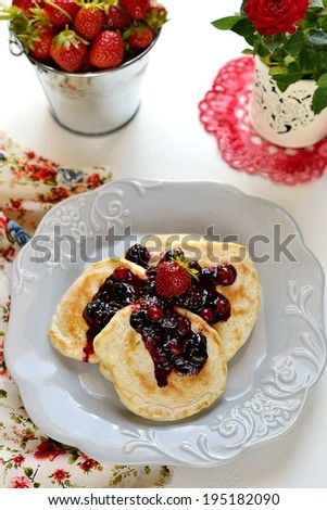 Fluffy pancakes with fresh berries in a plate. Selective focus