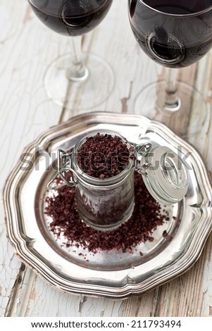 Red wine sea salt in a jar with glasses of wine. Selective focus, shallow depth of field