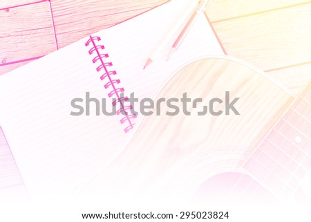 motion blur sweet Notebook and pencil on guitar,Writing music