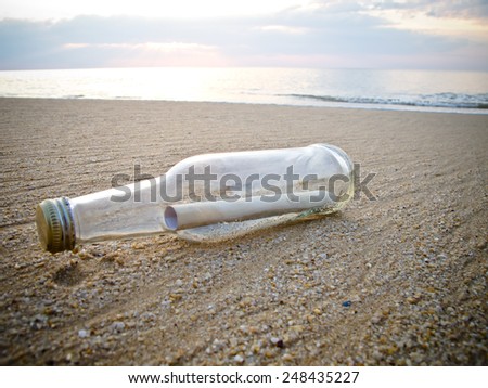 Old message in a Bottle on the sand Beach