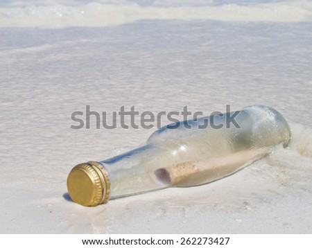 Old message in a Bottle on the sand Beach