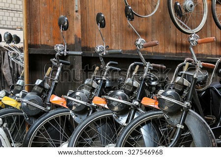 HERPEN, THE NETHERLANDS - OCTOBER 11, 2015: Row of vintage Solex mopeds for hire. The Solex mopeds were produced between 1946 and 1988 under the name Velosolex which is also the company name.