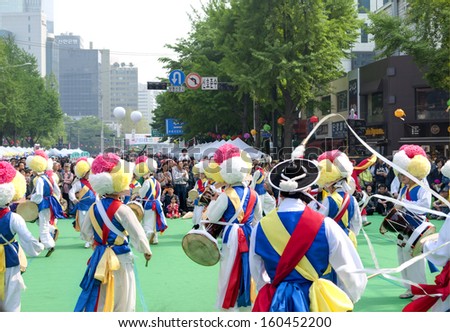 SEOUL KOREA MAY 12:  People are performing folk dance for celebration of Lotus Lantern Festival on the street in front of Jogyesa Temple on may 12 2013, Seoul, Korea.