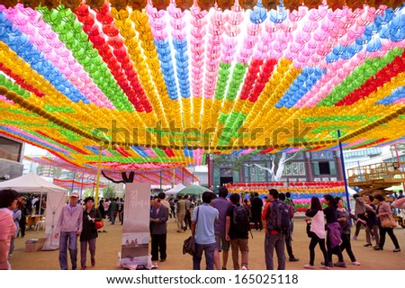SEOUL, SOUTH KOREA-MAY 12: People visting the Jogyesa Temple where hanging colorful lanterns for celebration of Lotus Lantern Festival on May 12, 2013 in Seoul, South Korea.