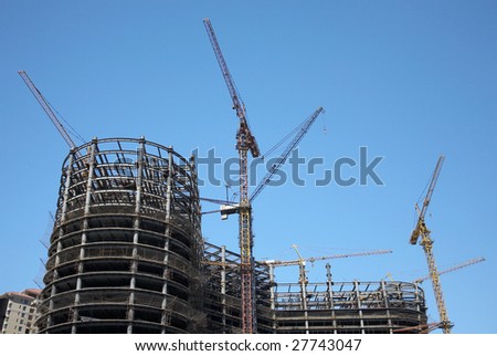 Urban construction site against blue sky.