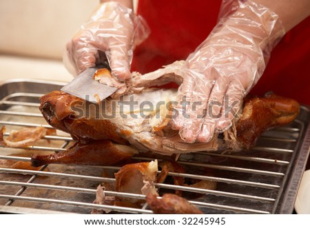 Preparing food - sliced duck meat into small pieces.