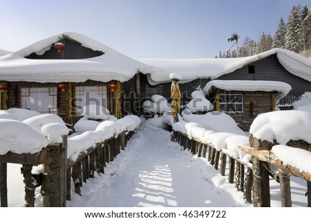 snow-covered wooden house. ( The Chinese characters on the red lanterns means \