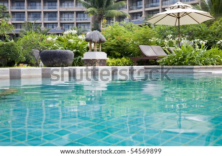 swimming pool  with chaise longue and umbrella