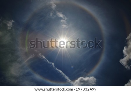 fantastic and beautiful sun halo in the sky with rainbow circle.