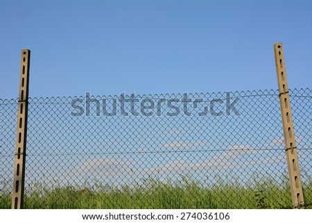 The fence in a field, the prison