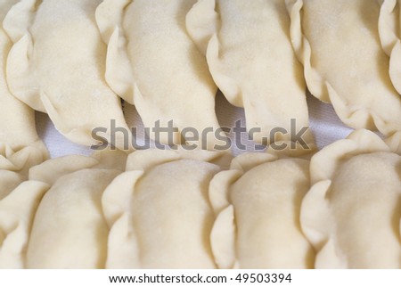 raw yellow dumplings with cheese and potatoes
