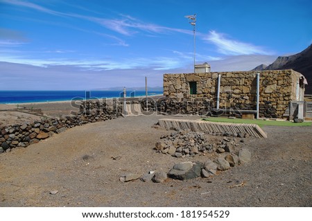 COFETE, FUERTEVENTURA, SPAIN - OCTOBER 24: Stone cottage at the Atlantic Ocean on October 24, 2011 in Cofete, Fuerteventura, Spain. Stone cottages are typical for rural regions of Fuerteventura Island