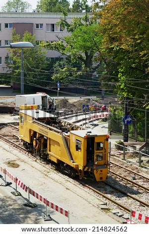 WARSAW, POLAND - AUGUST 30: Tram track renewal works on August 30, 2014 in Warsaw, Poland. Plasser & Theurer track tamping machine tamps down tram rails on 11 Listopada street in Warsaw.