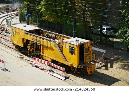WARSAW, POLAND - AUGUST 30: Tram track renewal works on August 30, 2014 in Warsaw, Poland. Plasser & Theurer track tamping machine tamps down tram rails on 11 Listopada street in Warsaw.