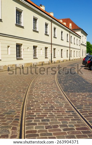 WARSAW, POLAND - MAY 6: Original pre-war tram tracks on Bohaterow Getta (Ghetto Heroes) Street with the adjacent Arsenal building on May 6, 2014 in Warsaw, Poland.