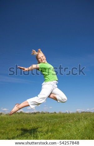 Girl Jump in the field under blue sky