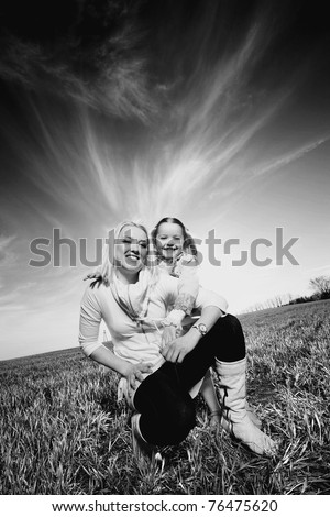 Mom and daughter play in the field. Black And White