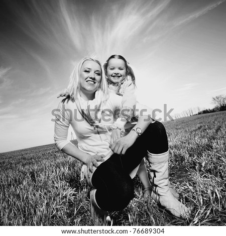 Mom and daughter play in the field. Black And White