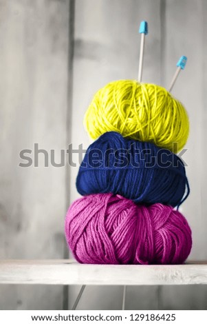 Photo of blue, purple and yellow balls of wool