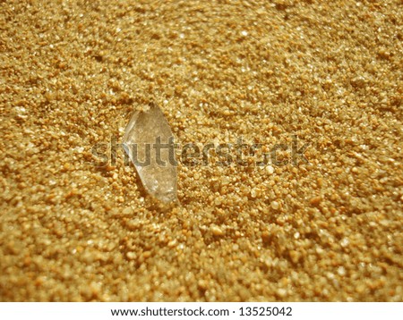 this photo is about gold sand and peace of glass
