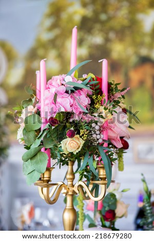 Floral arrangement to decorate the wedding feast, the bride and groom. Flowers, candles, vintage.