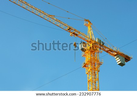 yellow crane tower on blue sky background