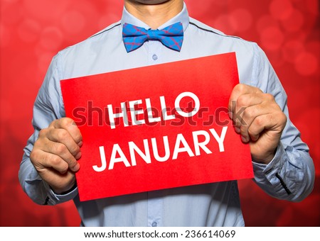 Businessman on red bokeh background with the text Hello january in a concept image
