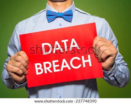 Man holding a card with the text Data breach on white background
