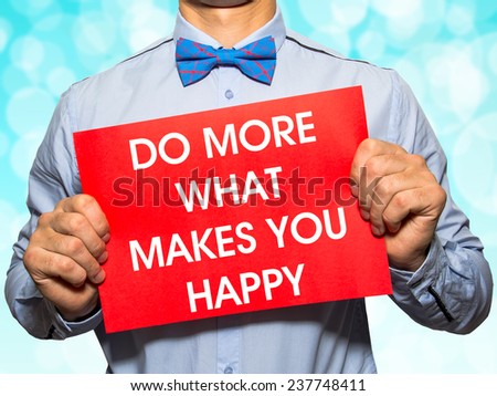 Man holding a card with the text Do more what makes you happy  on white background