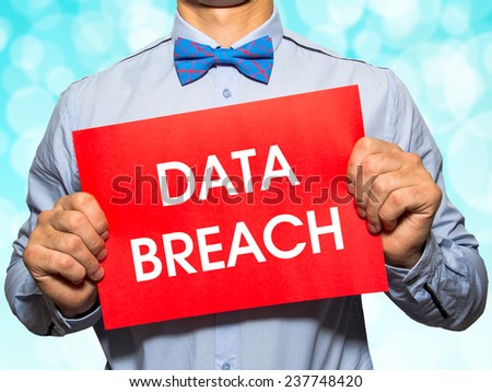 Man holding a card with the text Data breach on white background